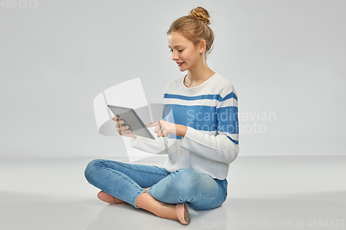 Image of happy smiling teenage girl using tablet computer