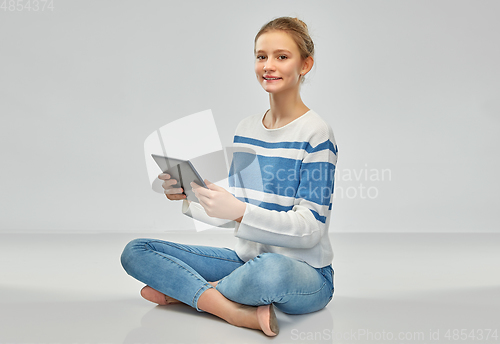 Image of happy smiling teenage girl using tablet computer