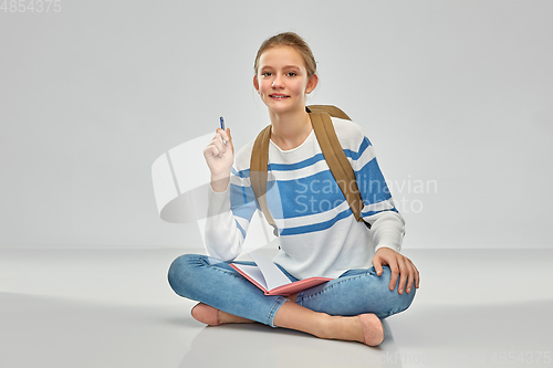 Image of teenage student girl with school bag and notebook