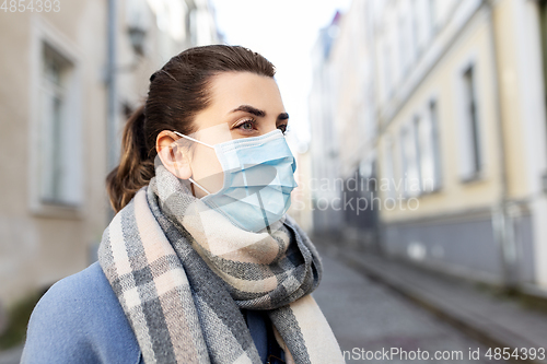 Image of woman wearing protective medical mask in city