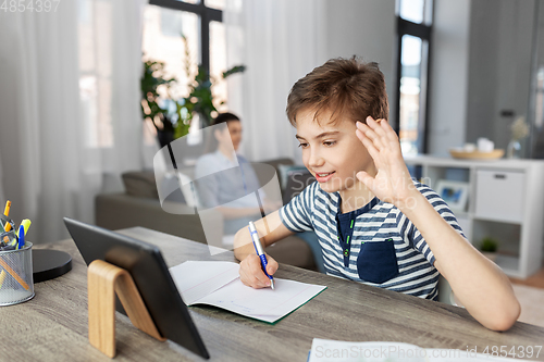 Image of boy having video call on tablet pc at home