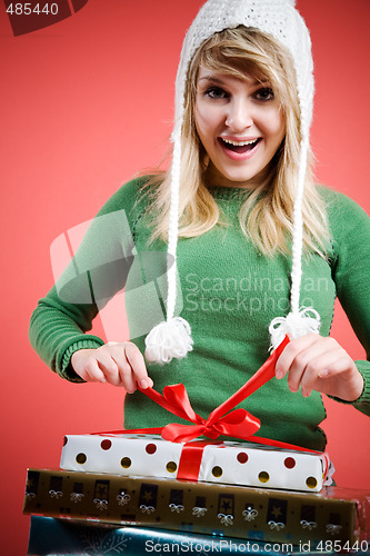 Image of Caucasian girl opening gift