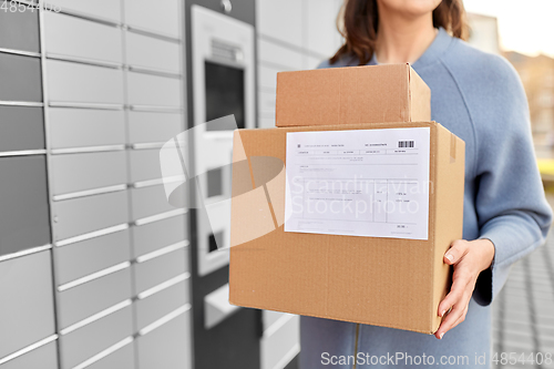 Image of woman with boxes at automated parcel machine