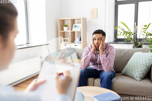 Image of man and psychologist at psychotherapy session