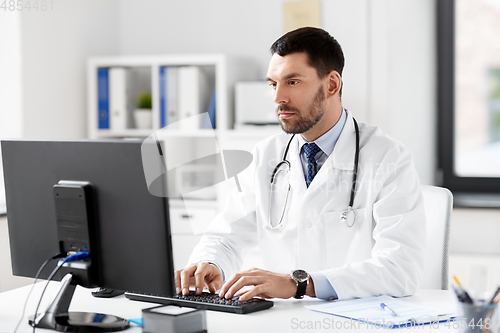 Image of male doctor with computer working at hospital