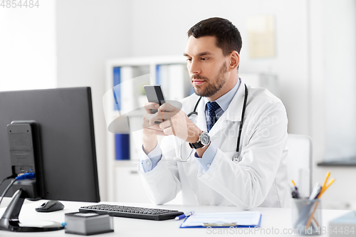 Image of male doctor with smartphone at hospital