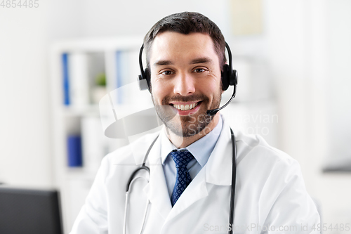 Image of happy male doctor with headset at hospital