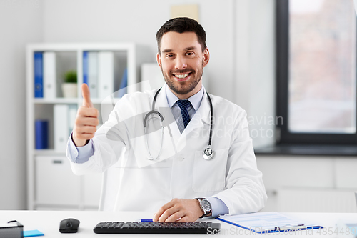 Image of happy male doctor showing thumbs up at hospital