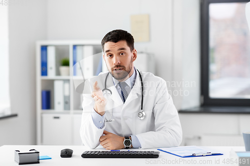 Image of male doctor having video conference at hospital