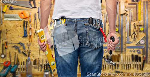 Image of close up of man with level and working tools