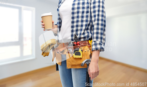 Image of woman with takeaway coffee cup and working tools