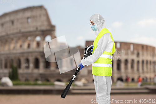 Image of sanitation worker in hazmat with pressure washer