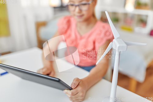 Image of student girl with tablet pc and wind turbine