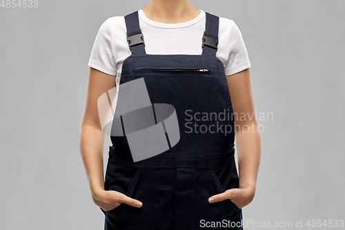 Image of close up of female painter or builder in overall
