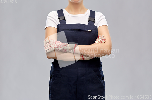 Image of close up of female painter or builder in overall