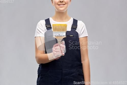 Image of close up of painter or builder with paint brush