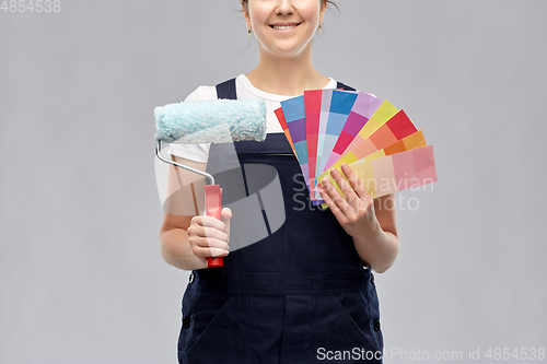 Image of close up of painter with roller and color charts