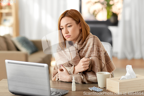 Image of sick woman having video call on tablet pc at home