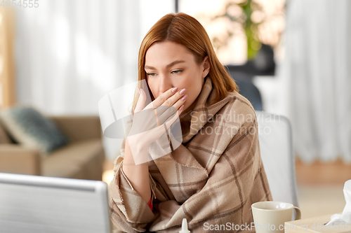 Image of sick woman having video call on laptop at home