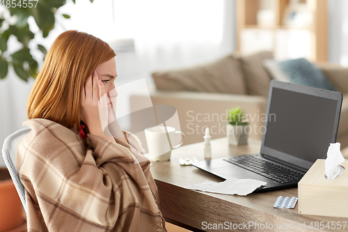 Image of sick woman having video call on laptop at home