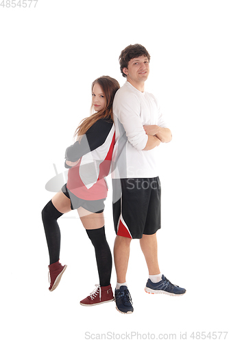 Image of Young couple in sportswear standing back to back