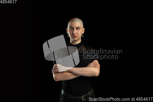 Image of Monochrome portrait of young caucasian bald woman on black background