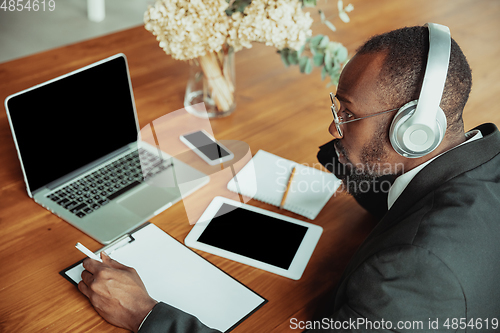 Image of Businessman or student working from home while being isolated or keep quarantine \'cause of coronavirus COVID-19