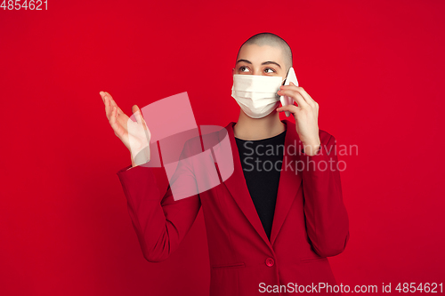 Image of Portrait of young caucasian bald woman on red background