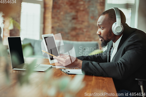 Image of Businessman or student working from home while being isolated or keep quarantine \'cause of coronavirus COVID-19