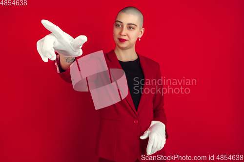 Image of Portrait of young caucasian bald woman on red background