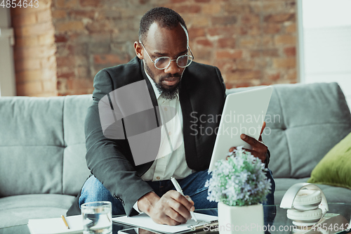 Image of Businessman or student working from home while being isolated or keep quarantine \'cause of coronavirus COVID-19