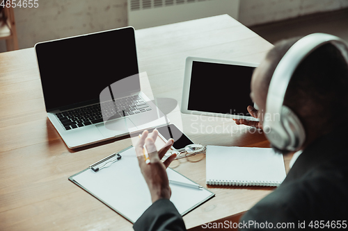 Image of Businessman or student working from home while being isolated or keep quarantine \'cause of coronavirus COVID-19