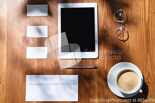 Image of Creative and cozy workplace at home office, inspirational mock up with plant shadows on table surface