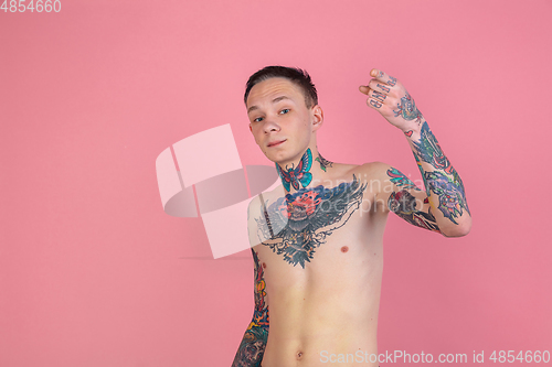 Image of Portrait of young man with freaky appearance on pink background