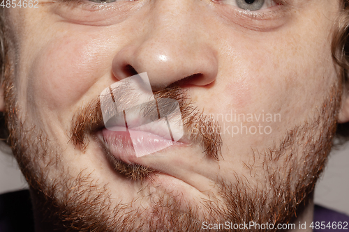 Image of Close-up male mouth illustrating emotions. Cosmetology, dentistry and beauty care, facial expression