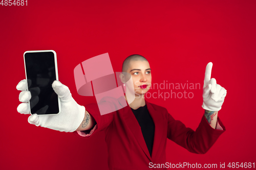 Image of Portrait of young caucasian bald woman on red background