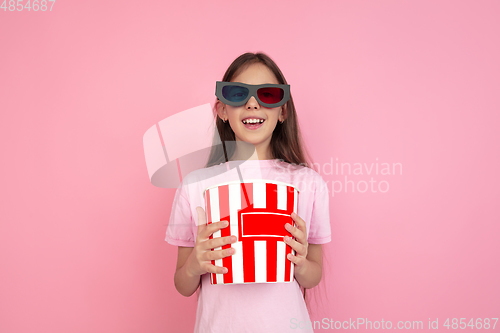 Image of Caucasian little girl portrait isolated on pink studio background, emotions concept
