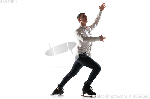 Image of Man figure skating isolated on white studio backgound with copyspace