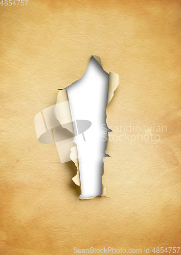 Image of Old torn parchment paper with hole