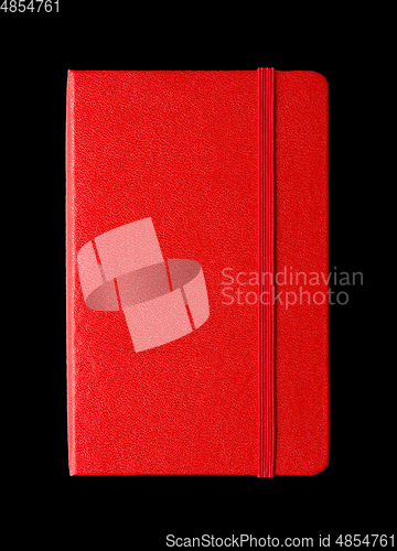Image of Red closed notebook isolated on black