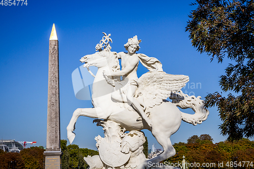 Image of Marble statue and Obelisk of Luxor in Concorde square, Paris