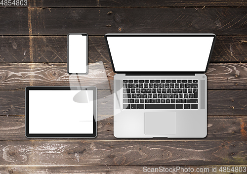 Image of Laptop, tablet and phone set mockup on a wooden background. 3D r