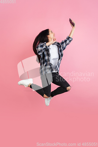 Image of Caucasian woman\'s portrait isolated on coral pink studio background with copyspace