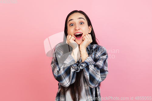 Image of Caucasian woman\'s portrait isolated on coral pink studio background with copyspace