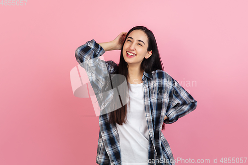 Image of Caucasian woman\'s portrait isolated on coral pink studio background with copyspace
