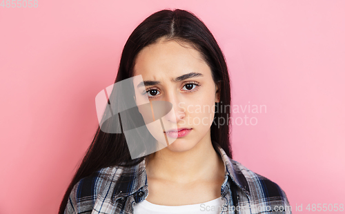 Image of Caucasian woman\'s portrait isolated on coral pink studio background with copyspace