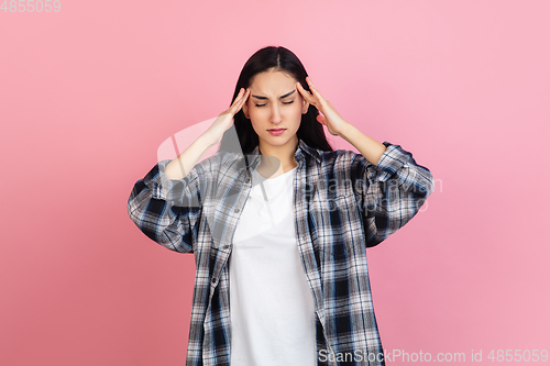 Image of Caucasian woman\'s portrait isolated on coral pink studio background with copyspace