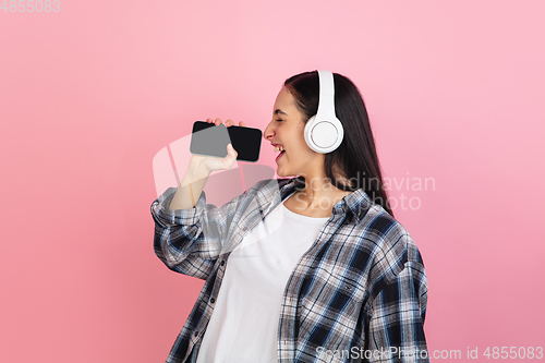 Image of Caucasian woman\'s portrait isolated on coral pink studio background with copyspace