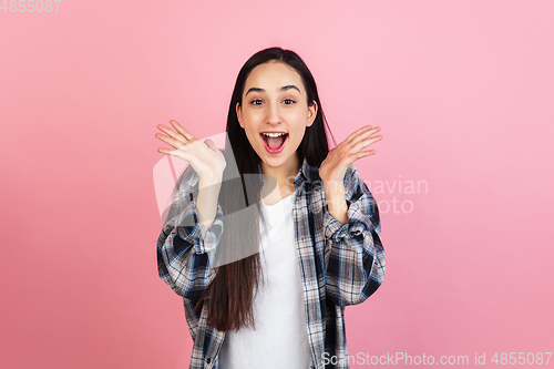 Image of Caucasian woman\'s portrait isolated on coral pink studio background with copyspace