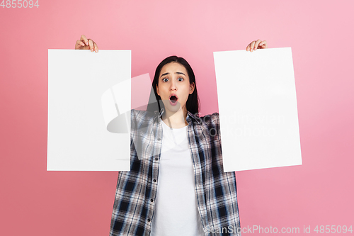 Image of Caucasian woman\'s portrait isolated on coral pink studio background with copyspace